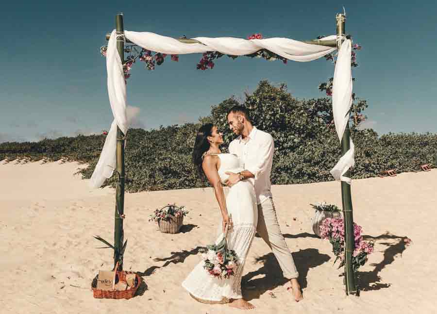 A photo of newlyweds on a beach.