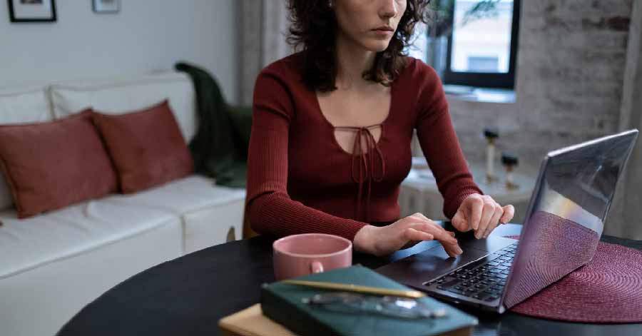 Woman sitting on a couch using her laptop